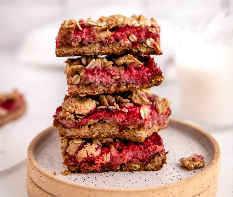 Raspberry oat bars on a simple round plate.